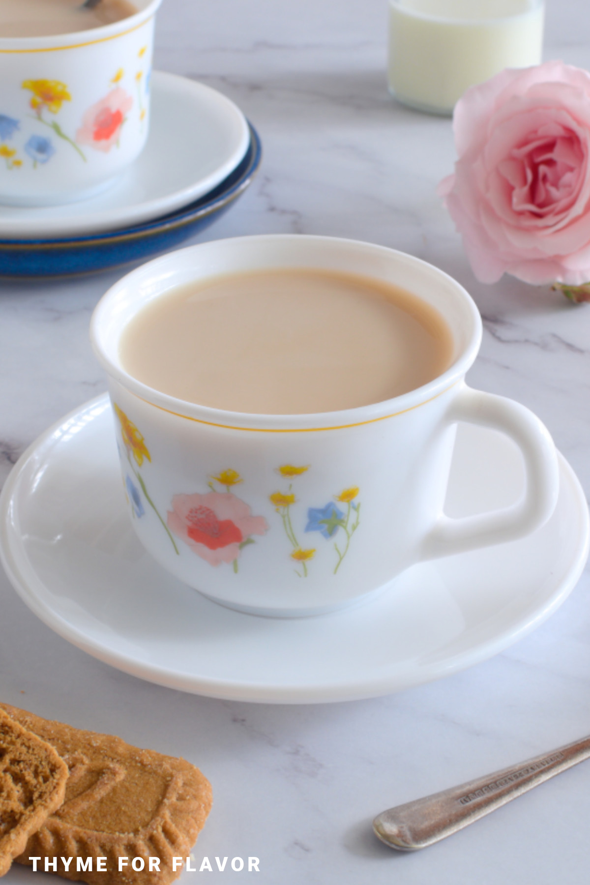 Earl grey tea with milk in a white mug.