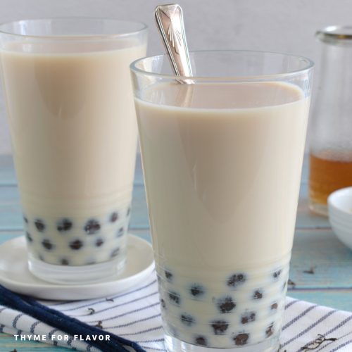 Close up image of two glasses of jasmine milk tea.