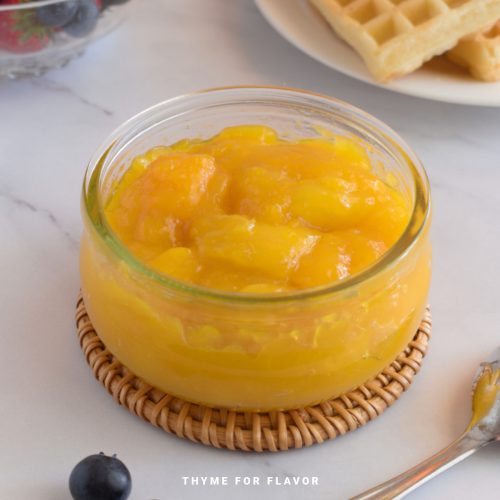 Mango compote in a glass container.