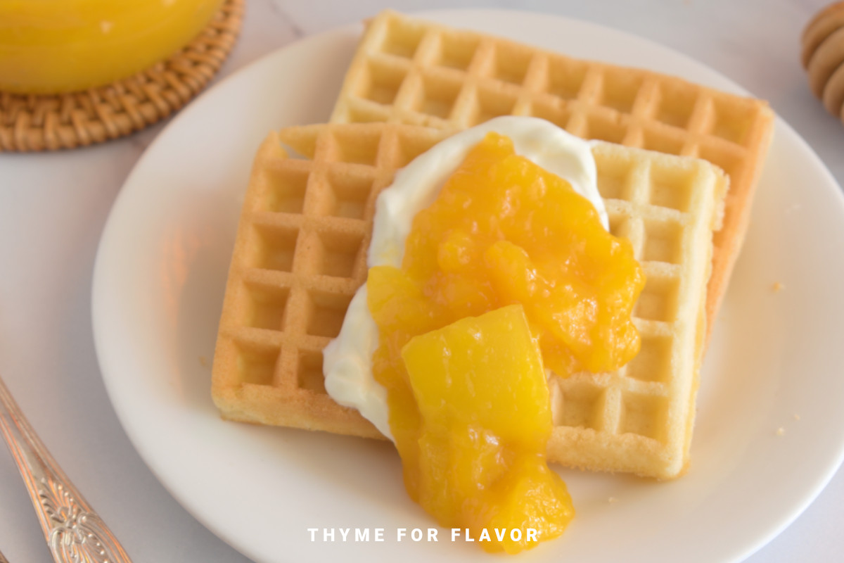 Mango compote and cream on waffles.