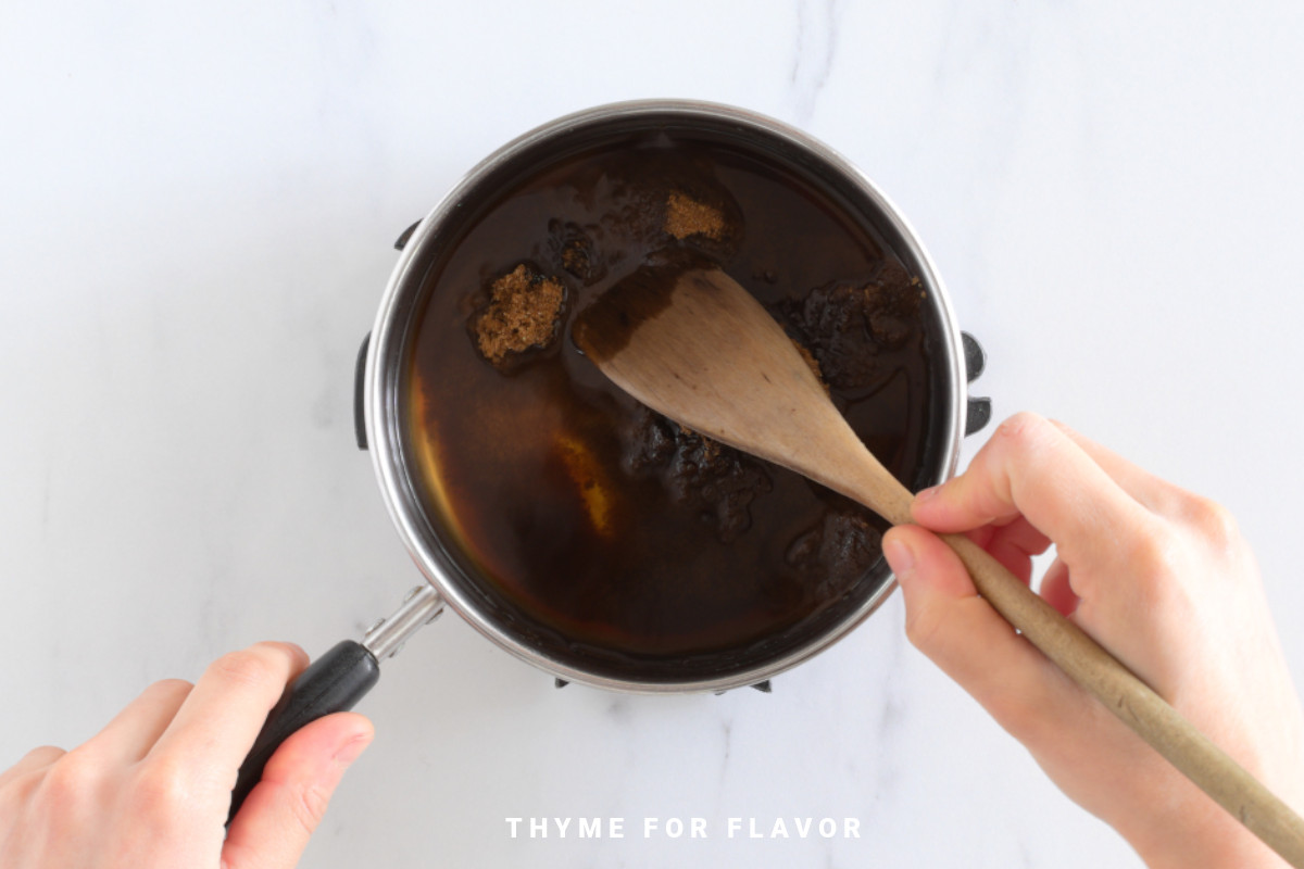 Mixing brown sugar and water in a saucepan.
