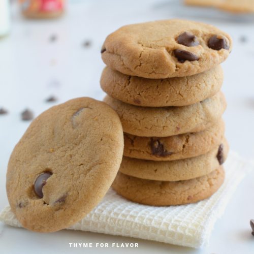 Stack of chocolate chip cookies on a napkin.
