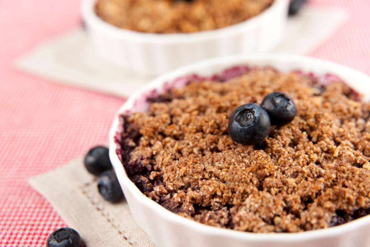 Air fryer blueberry cobbler on a beige colored napkin.