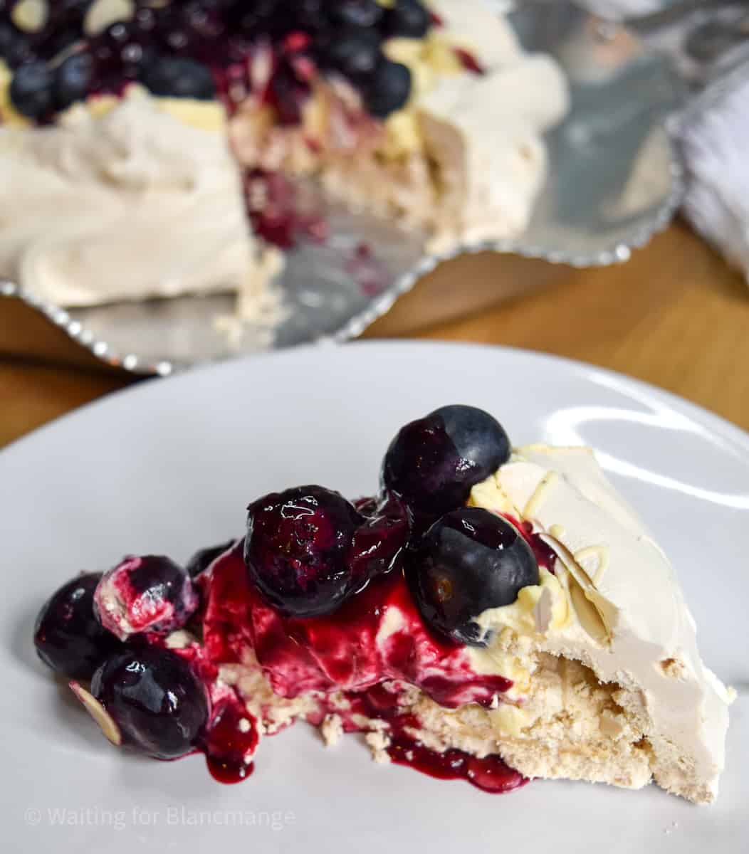 Blueberry pavlova with blueberry sauce and fresh blueberries on top.