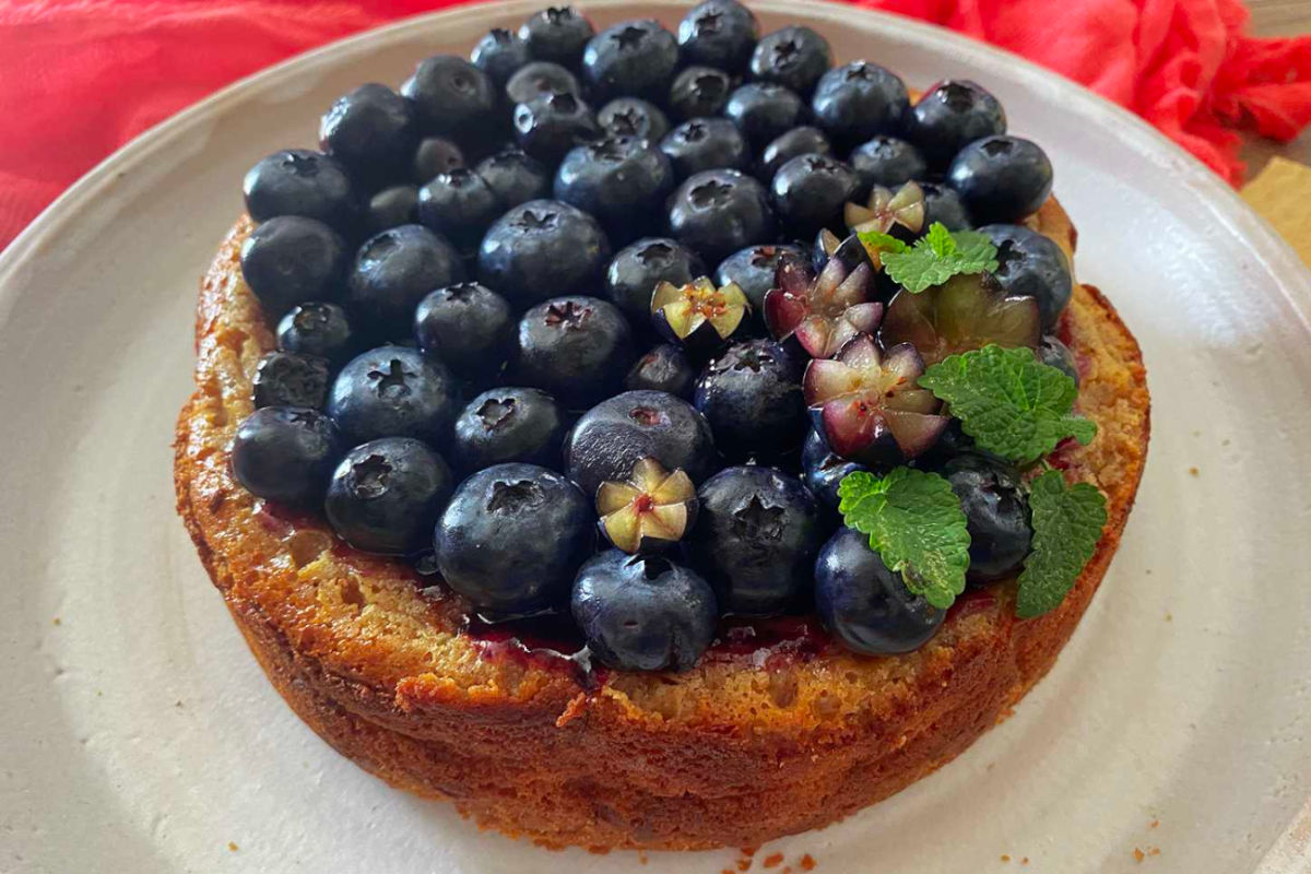 Instant pot blueberry cheesecake decorated with fresh blueberries and mint leaves.