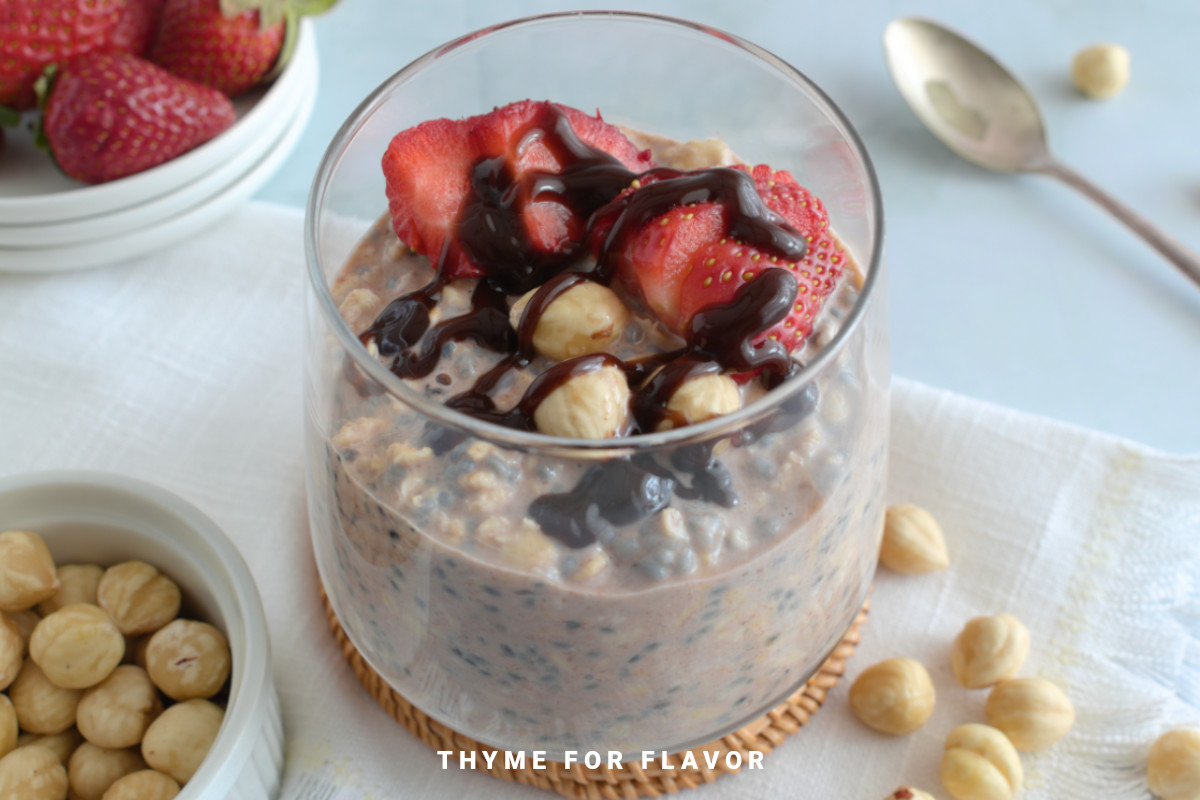 Close up image of Nutella overnight oats in a glass.