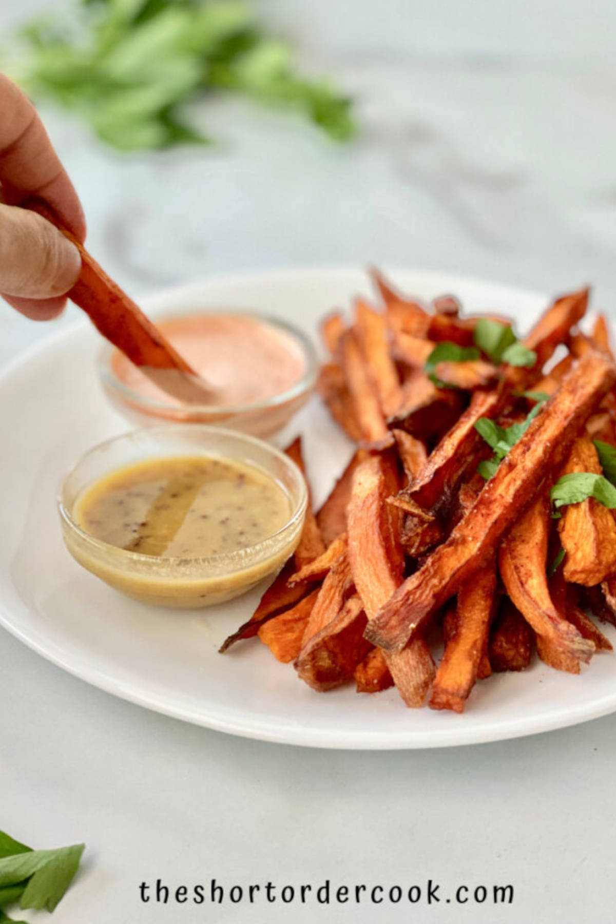 Sweet potato fries on a plate with dips.