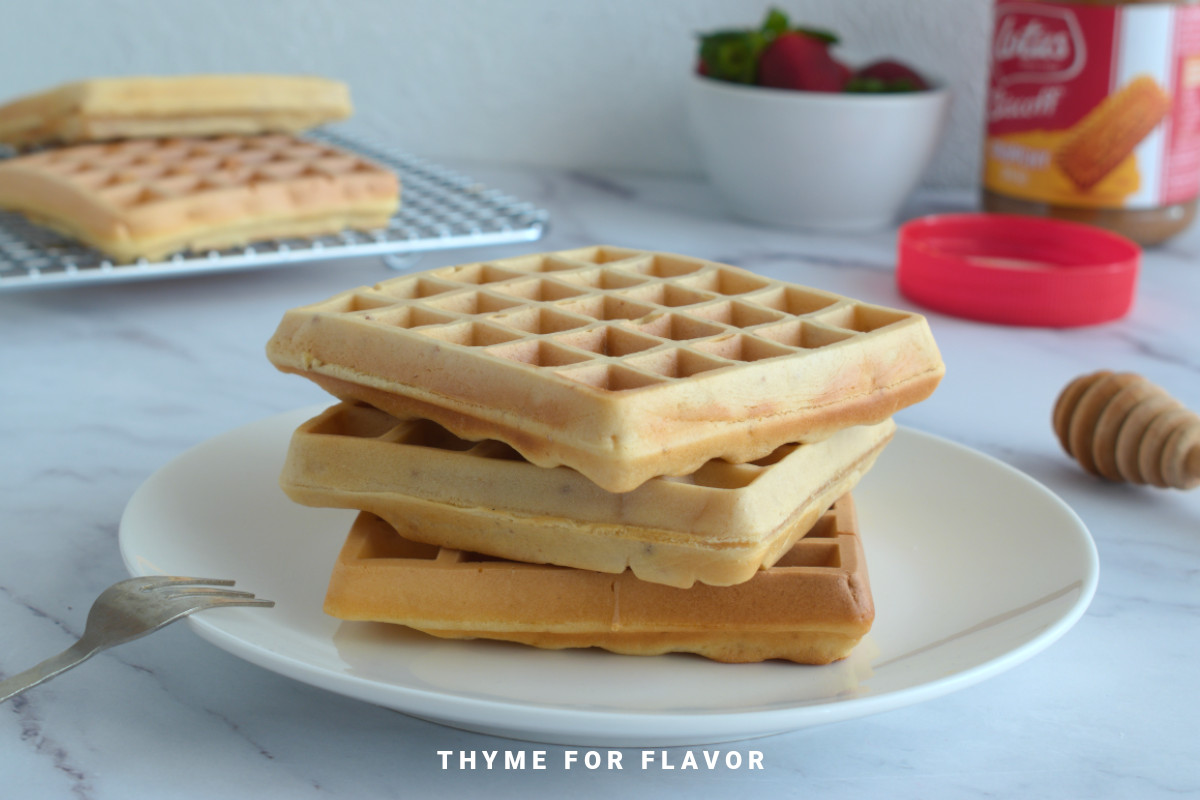 Close up image of a stack of waffles on a plate.