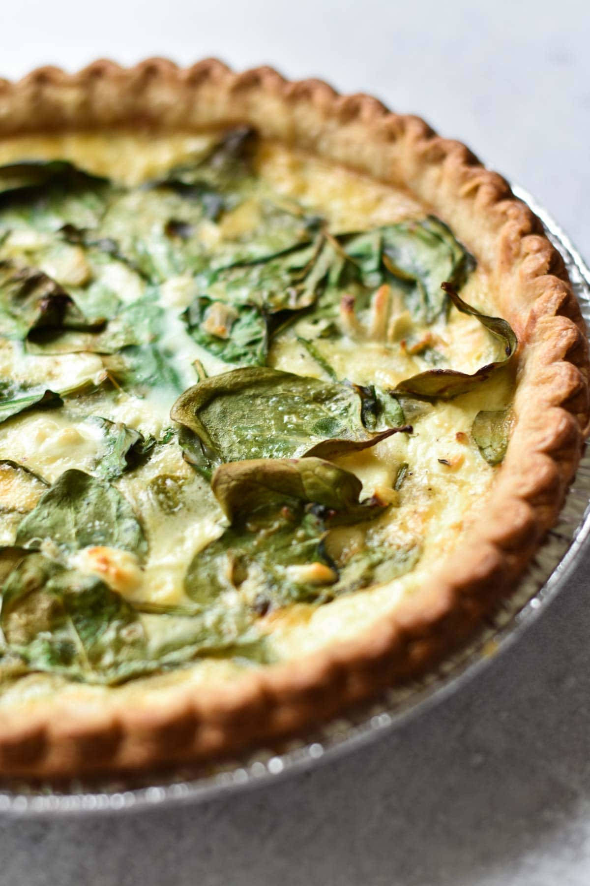 Close up image of spinach quiche.